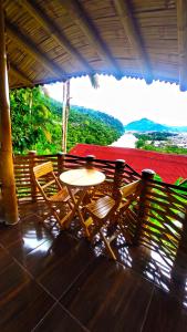 a table and chairs on a porch with a view at La Bella y El Leon in Tingo María