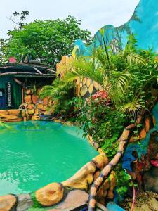 a pool of water in a garden with trees at Cahuita Vibe in Cahuita