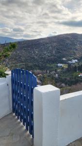 a group of blue containers sitting on top of a white wall at Eirini Home in Andros
