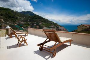 two chairs sitting on top of a roof at Villa La Zagara in Minori