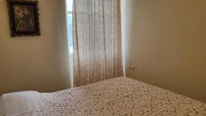 a bedroom with a bed and a window in a room at Eirini Home in Andros