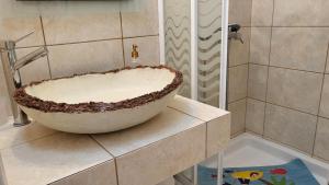 a bathroom with a large bowl sink on a counter at Eirini Home in Andros