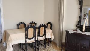 a dining room with a table and a mirror at Eirini Home in Andros