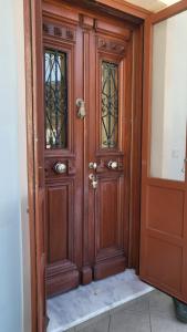 a wooden door with two glass windows in a room at Eirini Home in Andros