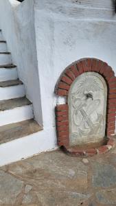 a brick door in a wall next to a staircase at Eirini Home in Andros