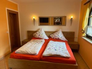 a bed with two pillows on it in a room at Ferienwohnung 1 Festungsblick in Königstein an der Elbe