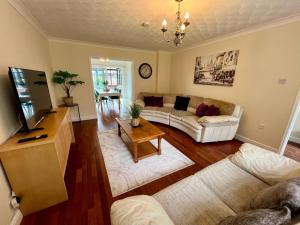 a living room with a couch and a table at Clovelly House in Norwich