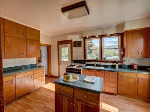 a large kitchen with wooden cabinets and a counter top at Left Field All Star Baseball Rentals in Oneonta