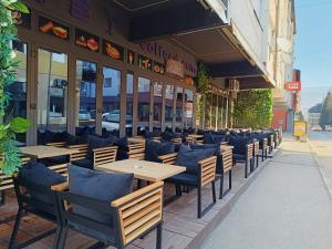 a row of tables and chairs outside of a restaurant at Apartmani Bašta in Višegrad