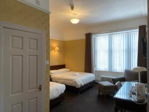 Voodi või voodid majutusasutuse Argyll Arms Hotel toas