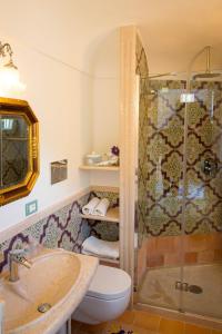 a bathroom with a shower and a toilet and a sink at Villa La Zagara in Minori