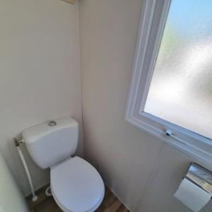 a bathroom with a white toilet and a window at La belle bleue in Hyères +10 photos
