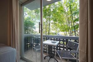 a balcony with a table and chairs and a window at Newly Apartment Just 5 Minutes to Brickell in Miami