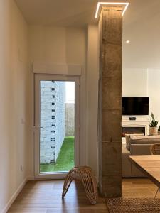 a living room with a glass door leading to a living room at Paraíso Rias Baixas in Pontevedra