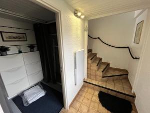 a hallway with a staircase in a house at Joli appartement au calme 