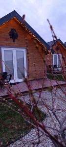 a house with a porch with lights on it at Spiska Dolina in Łapsze Niżne