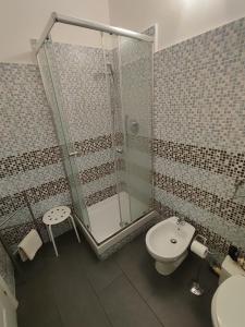 a bathroom with a shower and a toilet and a sink at Albergo Locanda Alambra in Genoa