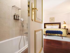 a bathroom with a bed and a tub and a shower at Casa Senhoras Rainhas - Óbidos - by Unlock Hotels in Óbidos +47 photos