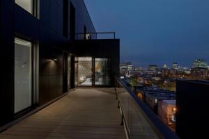 a balcony of a building with a view of a city at Hotel St-Thomas in Montréal