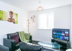 a living room with a couch and a tv at Levon House 2 Bed Apt with Netflix & Parking in Coventry in Longford