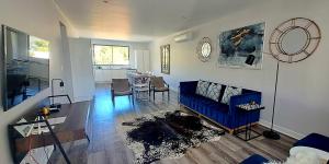 a living room with a blue couch and a table at 700m From Franschhoek Center in Franschhoek