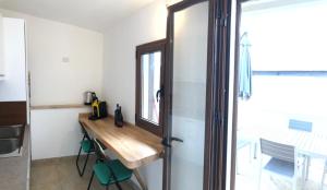 a kitchen with a wooden counter and a table at Camagna Country House in Santa Ninfa