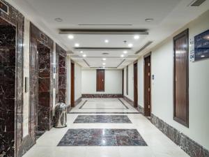 a corridor in a building with marble walls at Alayam Elite Hotel in Makkah