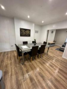 a dining room with a table and chairs at Spacious and homely House in Nottingham