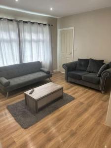 a living room with two couches and a coffee table at Spacious and homely House in Nottingham