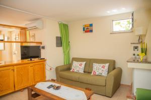 a living room with a couch and a table at Home Garden in Cala Gonone