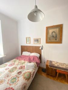 a bedroom with a bed and a lamp at Feel like at home in Warsaw