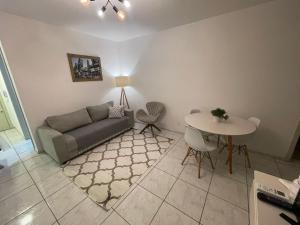 a living room with a couch and a table at Apto 2D Centro in Santa Cruz do Sul