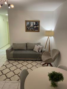 a living room with a couch and a table at Apto 2D Centro in Santa Cruz do Sul