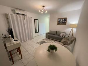 a living room with a table and a couch at Apto 2D Centro in Santa Cruz do Sul