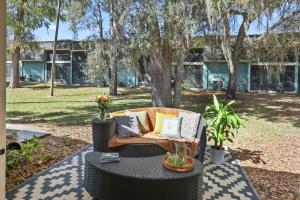 a couch sitting on a table in a yard at Ying Yang Suite King Bed Zen Condo in Gainesville