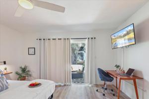 a bedroom with a desk and a bed with a laptop at Ying Yang Suite King Bed Zen Condo in Gainesville
