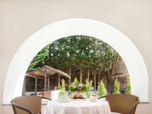 an archway with a table and chairs and trees at Casa Senhoras Rainhas - Óbidos - by Unlock Hotels in Óbidos