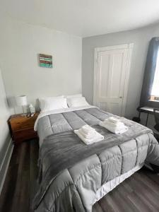 a bedroom with a large bed with two towels on it at Triple Play Apt 2 All Star Baseball Rentals in Oneonta +21 photos