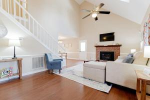 a living room with a couch and a fireplace at Breeze on Inn- Mins to Ft Jackson in Columbia