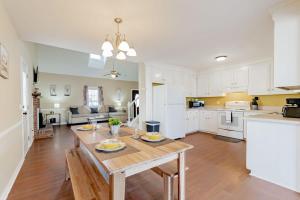 a kitchen with white cabinets and a wooden table at Breeze on Inn- Mins to Ft Jackson in Columbia