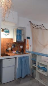 a kitchen with a sink and a counter top at La Casa del Callejón in Vejer de la Frontera