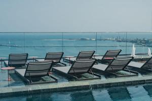 a group of chairs sitting next to a swimming pool at Hotel Gran Marquise in Fortaleza