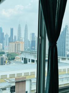 a view of a city skyline from a window at VUE Residences Klcc view ,2 min to HKL,Chowkit Monorail & MRT & BUS in Kuala Lumpur