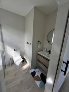 a small bathroom with a toilet and a sink at Solaris 2: Peaceful Condo close to Tourist Spots in Corinthe