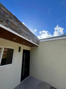 a side view of a building with a brick roof at Solaris 2: Peaceful Condo close to Tourist Spots in Corinthe