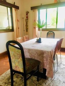 a dining room table with a pink table cloth and chairs at Nieta Chunu in Dar es Salaam