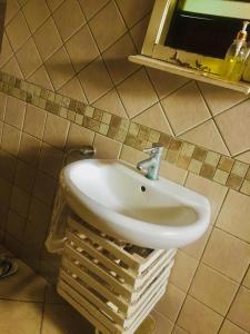 La salle de bains est pourvue d'un lavabo blanc sur un mur carrelé. dans l'établissement Nieta Chunu, à Dar es Salaam