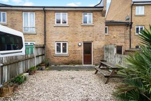 a brick house with a bench in front of it at Stylish 3 Bed in Central London - Garden in London