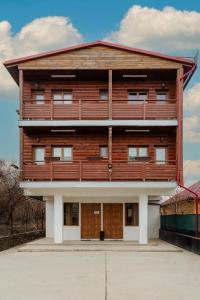 a large wooden building with aventh floor at Business Transit to Therme & Bucharest Airport in Săftica
