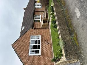an aerial view of a brick house with white windows at Immaculate 4-Bed Cottage in Knaresborough in Knaresborough